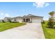 Spacious home featuring a large driveway and attached garages at 7513 Sw 56Th Pl, Ocala, FL 34474