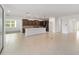 Open-concept living room and kitchen featuring tile flooring, stainless steel appliances, and ample natural light at 7513 Sw 56Th Pl, Ocala, FL 34474