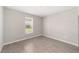 A well-lit bedroom featuring a window with neighborhood views and tile floors at 7745 Sw 56Th Pl, Ocala, FL 34474