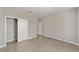 Spacious bedroom with closet and two entry doorways showcasing neutral walls and tile flooring at 7745 Sw 56Th Pl, Ocala, FL 34474