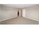A bright, carpeted bedroom features a closet and open door at 7745 Sw 56Th Pl, Ocala, FL 34474