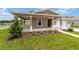 Charming home with a welcoming covered porch, neat landscaping, and an attached two-car garage at 7745 Sw 56Th Pl, Ocala, FL 34474