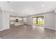 Spacious living area flowing into a modern kitchen, featuring tile floors and ample natural light at 7745 Sw 56Th Pl, Ocala, FL 34474
