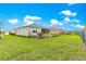 Wide backyard view, showcasing the lawn and the screened patio at 7891 Sw 89Th Cir, Ocala, FL 34481