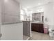 Bathroom with glass-enclosed shower, dual vanity with granite countertop, and tile flooring offers an updated look at 7891 Sw 89Th Cir, Ocala, FL 34481
