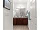 Well-lit bathroom featuring a large vanity and a framed mirror at 7891 Sw 89Th Cir, Ocala, FL 34481