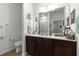 Bathroom with a brown vanity cabinet, a framed mirror and tile flooring at 7891 Sw 89Th Cir, Ocala, FL 34481