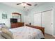 Well-lit bedroom with light blue walls, wood-look floors, and a ceiling fan at 7891 Sw 89Th Cir, Ocala, FL 34481