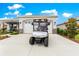 Home exterior shows an attached garage and golf cart parked on driveway at 7891 Sw 89Th Cir, Ocala, FL 34481