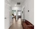 Hallway with hardwood floors leading to bedrooms and other living spaces at 7891 Sw 89Th Cir, Ocala, FL 34481