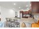Gourmet kitchen features stainless steel appliances, granite countertops, and a center island with seating at 7891 Sw 89Th Cir, Ocala, FL 34481