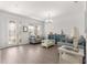 Cozy living room with natural light, hardwood flooring, and modern furnishings at 7891 Sw 89Th Cir, Ocala, FL 34481