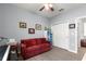 Versatile bonus room with a red couch and organized storage, perfect for an office or entertainment area at 7891 Sw 89Th Cir, Ocala, FL 34481