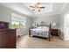 Comfortable main bedroom with neutral walls, a ceiling fan and a large window at 7891 Sw 89Th Cir, Ocala, FL 34481