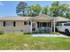 Charming single-story home with a covered porch, car port and well-maintained lawn at 8368 Sw 105Th Pl, Ocala, FL 34481