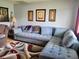 Comfortable living room featuring a large sectional sofa and decorative art pieces at 8368 Sw 105Th Pl, Ocala, FL 34481