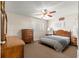 This bedroom features a comfortable bed, dressers, carpeted floors and a ceiling fan at 8625 Sw 94Th Ln # A, Ocala, FL 34481