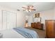 Bright bedroom features a ceiling fan, carpeted floor, and a closet with folding doors at 8625 Sw 94Th Ln # A, Ocala, FL 34481