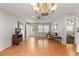 Open living room with tile flooring and decorative chandelier at 8625 Sw 94Th Ln # A, Ocala, FL 34481