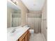 Bathroom featuring vanity, toilet, mirror and shower with curtain at 8670 Se 141St Pl, Summerfield, FL 34491