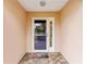Inviting entrance featuring a decorative storm door and tile flooring with a 'Welcome' mat at 8670 Se 141St Pl, Summerfield, FL 34491