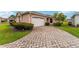 Charming single-story home showcasing beautiful brick paver driveway at 8670 Se 141St Pl, Summerfield, FL 34491
