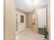 Bright foyer featuring tile flooring, decorative glass door, and a plant in the corner at 8670 Se 141St Pl, Summerfield, FL 34491