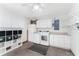 Well-organized garage with laundry area, overhead storage, and shelving, maximizing space at 8670 Se 141St Pl, Summerfield, FL 34491