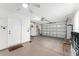 Spacious garage has an open door, bright lighting, and ample storage space for organization at 8670 Se 141St Pl, Summerfield, FL 34491