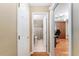 Hallway view of bathroom and office, showing connectivity and layout at 8670 Se 141St Pl, Summerfield, FL 34491
