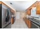 Well-lit kitchen with stainless steel fridge and appliances and sleek granite countertops at 8670 Se 141St Pl, Summerfield, FL 34491
