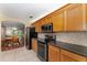 Open kitchen layout with stainless steel appliances flowing into dining area at 8670 Se 141St Pl, Summerfield, FL 34491