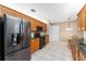 Modern kitchen features stainless steel appliances, granite countertops, and wooden cabinetry at 8670 Se 141St Pl, Summerfield, FL 34491