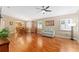 Spacious living room boasts hardwood floors, abundant natural light, and a ceiling fan at 8670 Se 141St Pl, Summerfield, FL 34491