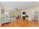 Bright living room with hardwood floors, ceiling fan, and sliding glass doors to lanai at 8670 Se 141St Pl, Summerfield, FL 34491