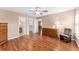 Open main bedroom with wood floors and multiple closets leading to bathroom at 8670 Se 141St Pl, Summerfield, FL 34491