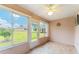 Relaxing sunroom with tile floors and walls of windows provides a view of the backyard at 8670 Se 141St Pl, Summerfield, FL 34491