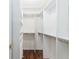 Bright and spacious walk-in closet featuring white built-in shelving for optimal storage at 8670 Se 141St Pl, Summerfield, FL 34491