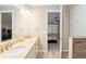 Open bathroom with double vanity and access to shower and bedroom, with neutral color palette at 8878 Sw 103Rd Cir, Ocala, FL 34481