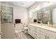 Bathroom with a double sink vanity, a glass-enclosed shower with a built-in seat, and tile flooring at 8878 Sw 103Rd Cir, Ocala, FL 34481