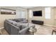 Comfortable living room features a large sectional couch, stylish decor, and natural light at 8878 Sw 103Rd Cir, Ocala, FL 34481