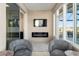 Bright sunroom featuring a fireplace, TV, and sliding doors to the outside at 8878 Sw 103Rd Cir, Ocala, FL 34481