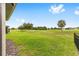 Expansive backyard view featuring lush green grass and picturesque golf course views with mature trees on a sunny day at 8989 Sw 57Th Place Rd, Ocala, FL 34481