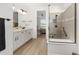 Modern bathroom showcasing dual vanities, walk-in shower and bedroom access at 8989 Sw 57Th Place Rd, Ocala, FL 34481