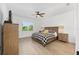 Bright bedroom features wood-look flooring, a ceiling fan and neutral decor at 8989 Sw 57Th Place Rd, Ocala, FL 34481