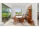 Bright dining area featuring wood table and chairs, large window, and sliding glass door at 8989 Sw 57Th Place Rd, Ocala, FL 34481
