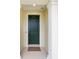 Elegant front door with a stylish dark color and sidelights, creating a welcoming entrance at 8989 Sw 57Th Place Rd, Ocala, FL 34481