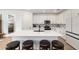 Kitchen featuring white cabinets, patterned backsplash, and island with seating at 8989 Sw 57Th Place Rd, Ocala, FL 34481