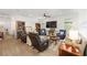 Spacious living room with ample seating, a large TV, and natural light from the windows at 8989 Sw 57Th Place Rd, Ocala, FL 34481