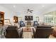 Spacious living room with ample seating, a large TV, and natural light from the windows at 8989 Sw 57Th Place Rd, Ocala, FL 34481
